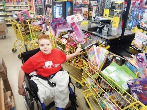 B.J. with a train of shopping carts filled with toys for patients at Riley Hospital for Children.