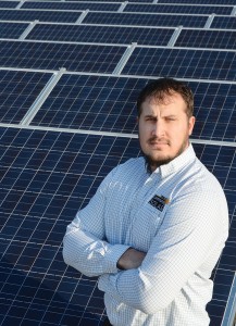 Jason Monroe, energy management supervisor at Tipmont REMC, stands in front of Tipmont's community solar farm — the first in Indiana. Tipmont took advantage of economies of scale and photovoltaic pricing that has fallen 70 percent since 2010 to build the array and offer shares of its generation to consumers who want to support green energy at competitive pricing.