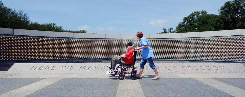 11:44 am: Passing the “Freedom Wall” at the WWII memorial is veteran Wayne Lambert and guardian, daughter Jan Pyle. As the inscription reads, the stars “mark the price of freedom.” Over 4,000 gold stars, each representing 100 U.S. military deaths in the war, make up the wall. A tour guide noted to the group that if the World War II Memorial had been designed like the Vietnam Veterans Memorial as a wall with the name of each casualty inscribed, the WWII wall would have to have been nine times larger than the Vietnam memorial.