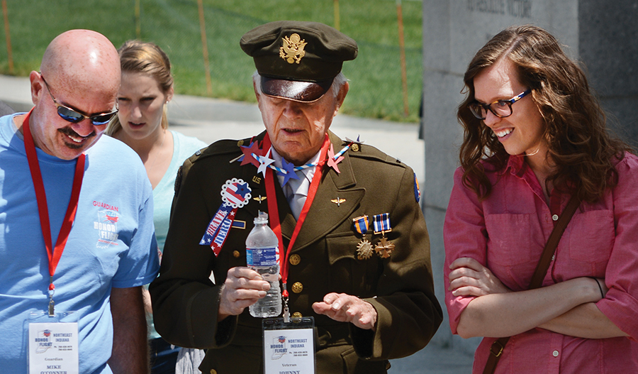 11:58 am: (left) Johnny Smiley, center, talks about his experiences during World War II with his Honor Flight guardian Mike O’Conner and daughter Carlie O’Conner at the World War II Memorial. Smiley, 91, of Oakford, who wore his uniform throughout the day, was a B-17 bomber pilot during World War II. Carlie met the group at the memorial; the Kokomo native is working on her doctorate in D.C.