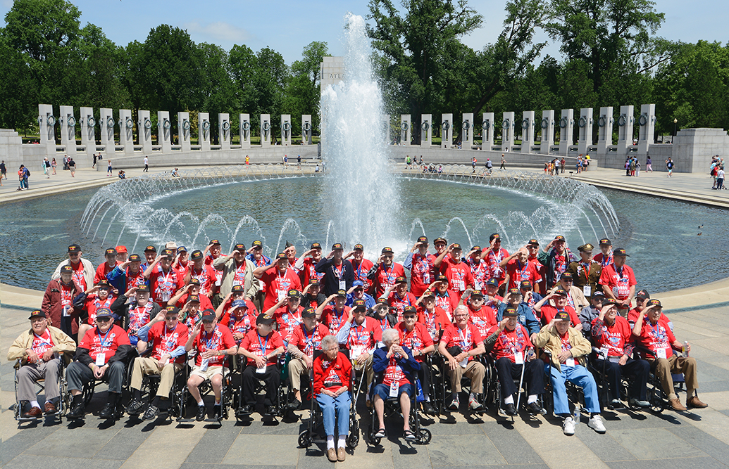 12:18 pm: The 70 veterans on Honor Flight Northeast Indiana’s 16th flight May 20 gather for a group photo at the World War II Memorial. The group included two women — Polly Lipscomb, front row left, who was a first lieutenant in the Army Nurse Corps and Betty “Junebug” Harshman, front row right, who was a seaman, first class, in the Navy WAVES.