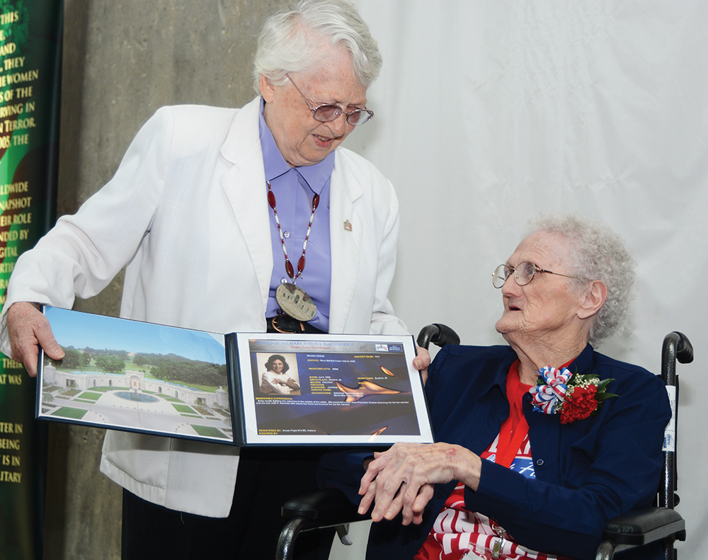 3:04 pm: Betty “Junebug” Harshman, 91, receives a special presentation from retired U.S. Air Force Brig. Gen. Wilma L. Vaught at the Women In Military Service For America Memorial to recognize her service in the Navy WAVES. A presentation was also made to Polly Lipscomb. The memorial is at the entrance to Arlington National Cemetery.