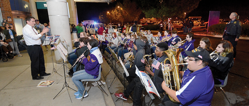 10:19 pm: On what became a cool rainy night, members of the New Haven High School band cap off the long day with patriotic songs to bid the veterans farewell as Honor Flight participants and their families head home from the Fort Wayne airport.