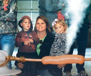 Thar she blows! A hot dog, cooked from the inside with electric current passing through the bare copper wire, lets loose steam — showing Kade and Bella Jones, both 4, and their mom, Lacey, the silent and deadly power of electricity. The display was part of Marshall County REMC’s safety program last month at the Culver Young Farmers Ag Safety Day at North Central Co-op in Plymouth. The Jones family, Fulton County REMC consumers, came up from Rochester for the program.