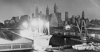 A freighter glows in a Brooklyn harbor while Manhattan’s skyline is shrouded in darkness during the November 1965 blackout. Some small pockets of New York City kept power during the massive 13-hour blackout, and, in some towns around the Northeast, quick-acting utility operators, monitoring their system, threw switches to disconnect their utilities from the grid before they were caught in the cascading failure. World Telegram & Sun photo by Stanley Wolfson/Library of Congress