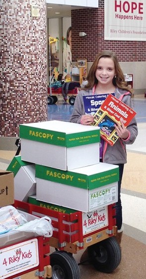 Allison Baker delivers boxes of coloring books and crayons to Riley Hospital for Children in Indianapolis last February.