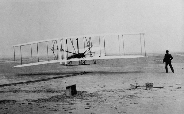 Wilbur Wright, who was born in Indiana, pilots the first flight of the flyer he and brother Orville, right, at Kitty Hawk, North Carolina in 1903.