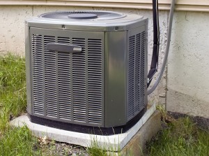 Central Air Conditioning unit outside home near grass