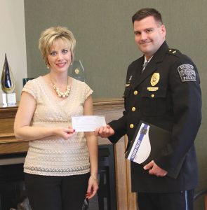 Kankakee Valley REMC’s Amanda Steeb presents an Operation Round Up check to Chief Joshua Noel from the Hebron Police Department.