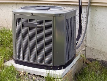 Central Air Conditioning unit outside home near grass