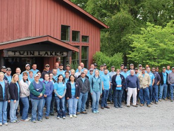Tipmont staff members pose outside a red barn at Twin Lakes Camp.