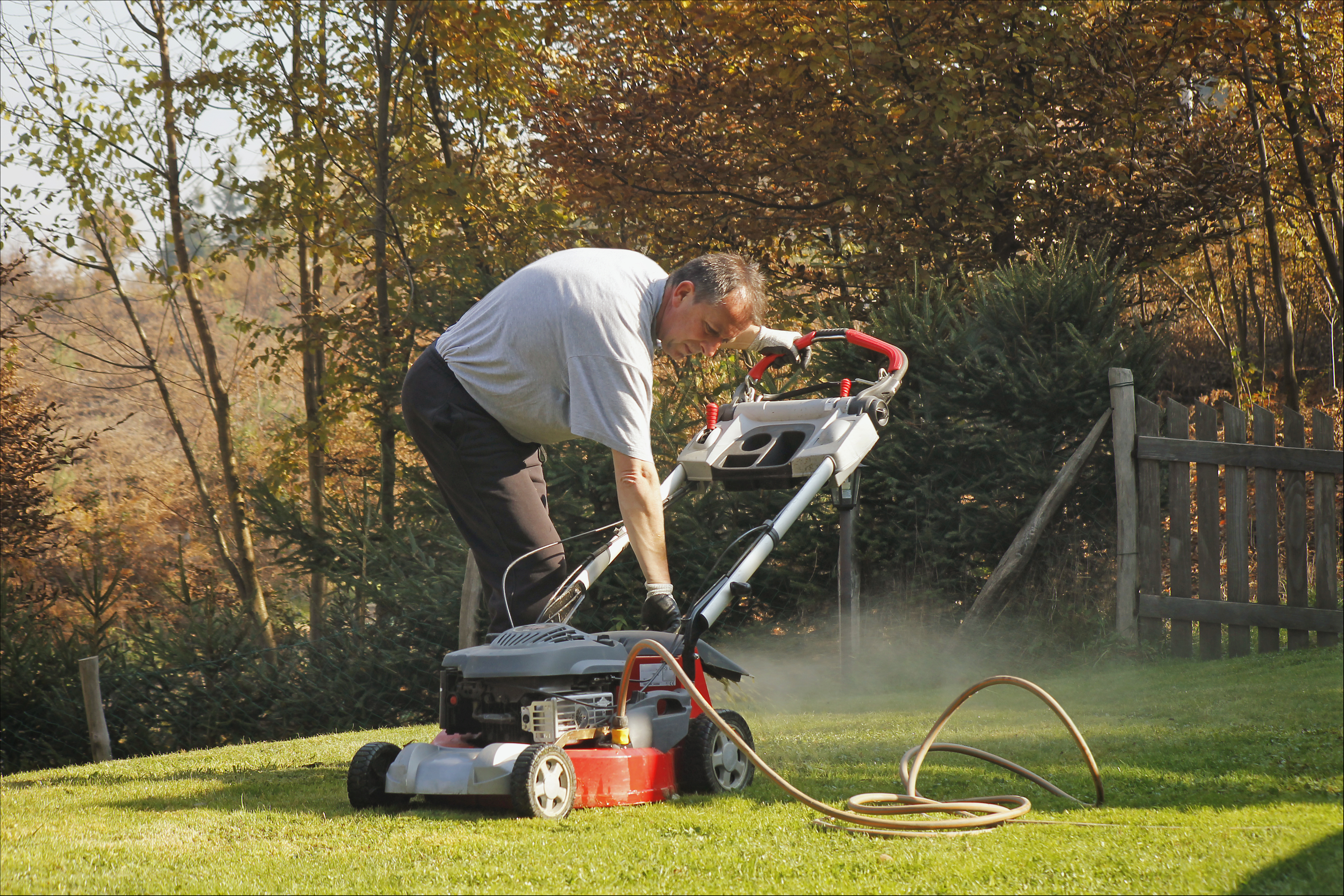 Photo of man with electric lawn mower