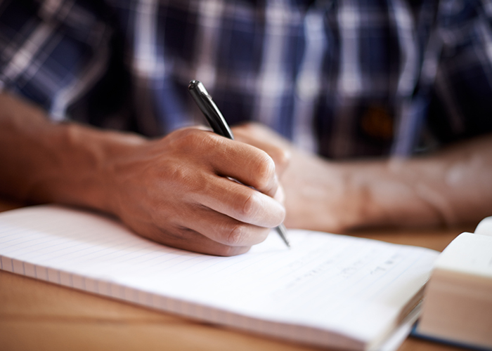 Person writing on tablet