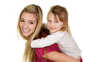 Babysitter Giving Little Girl a Piggy Back Ride