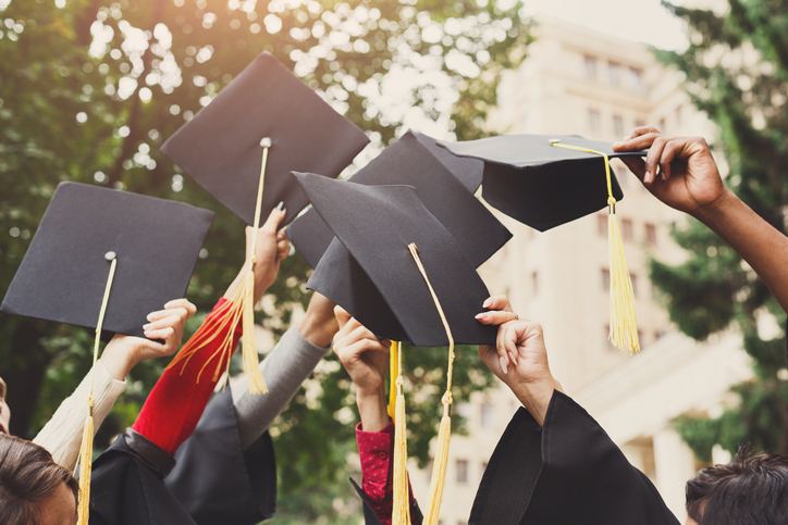 Photo of graduates with caps and gowns