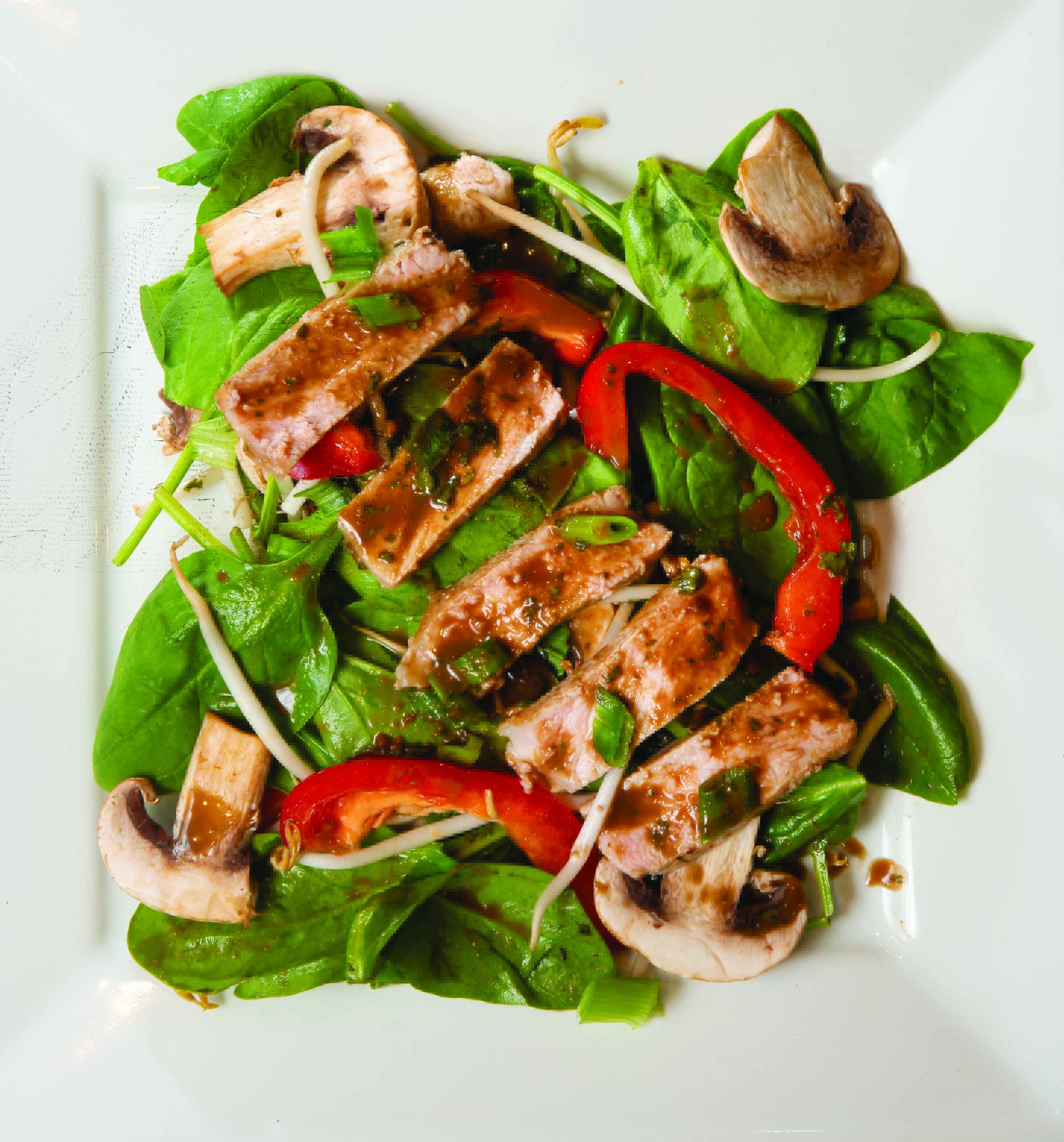 Oriental Pork Chops on Spinach with Thai Peanut Dressing - Indiana Connection