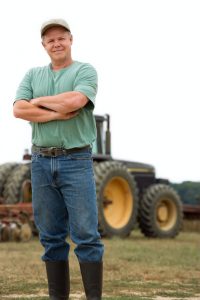 Farmer in front of tractor