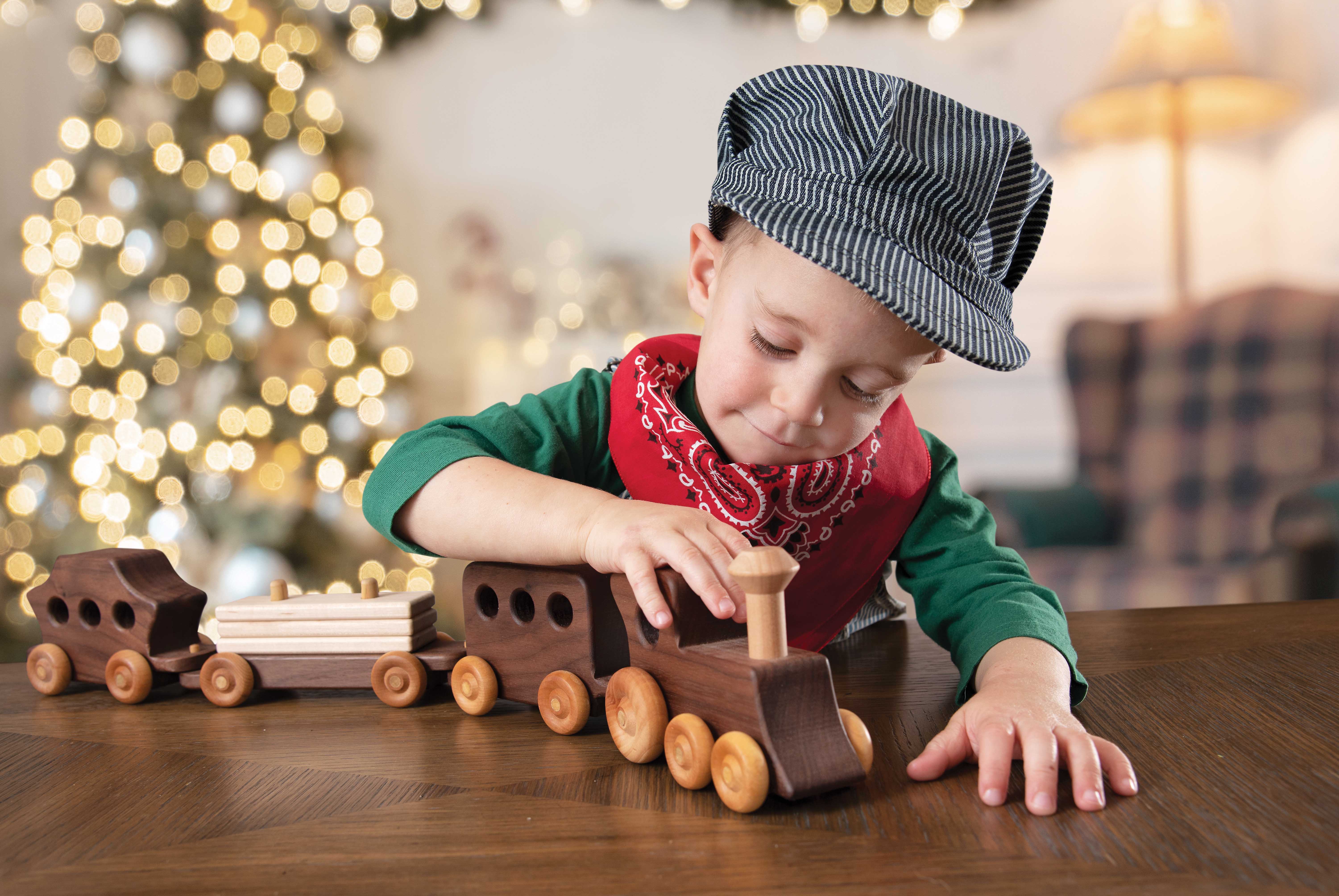 Boy playing with a toy train
