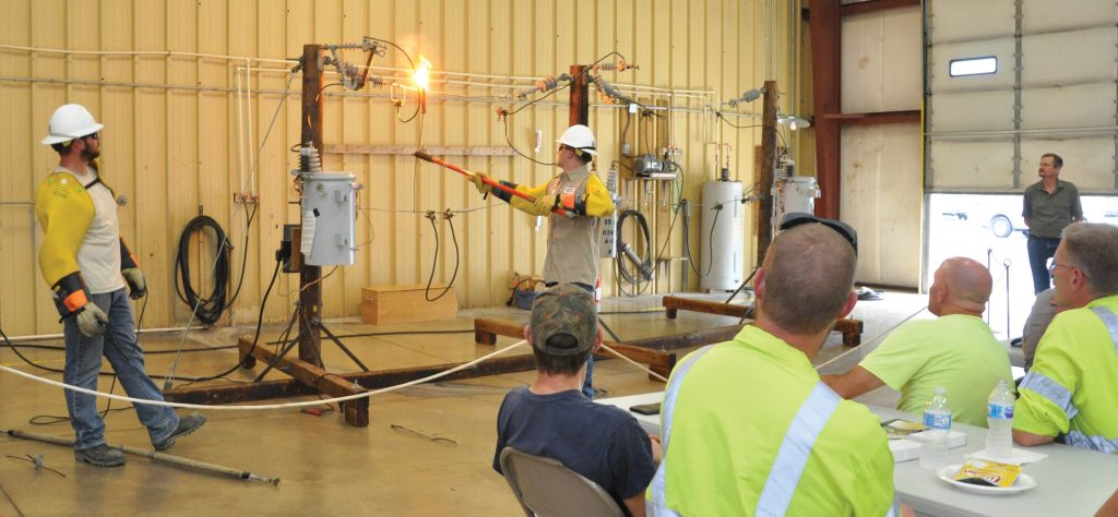 Noble REMC linemen conducting a live wire demonstration