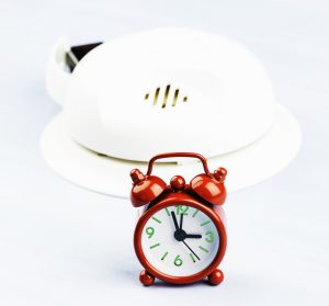 Photo of a clock and smoke detector