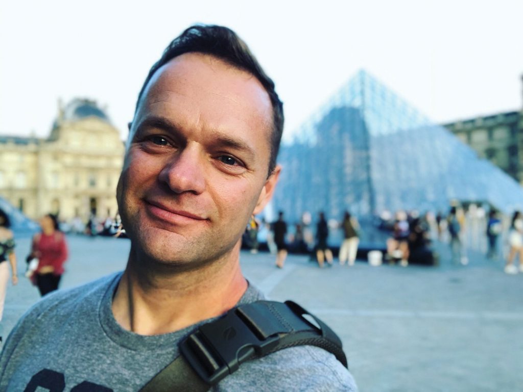 Nate Heck in front of the Louvre in Paris.