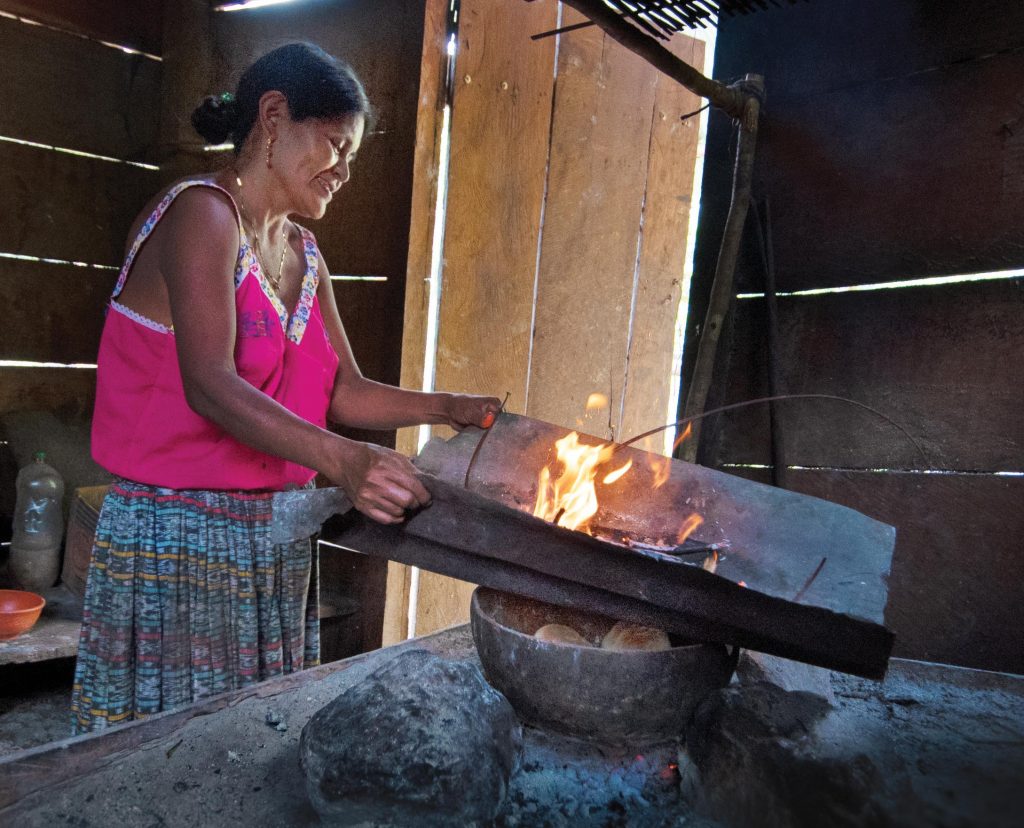 Photo of Hilaria Chub cooking in her kitchen in Guatemala.