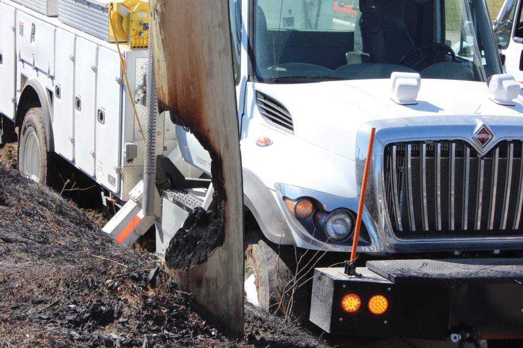 Photo of burnt pole and utility truck