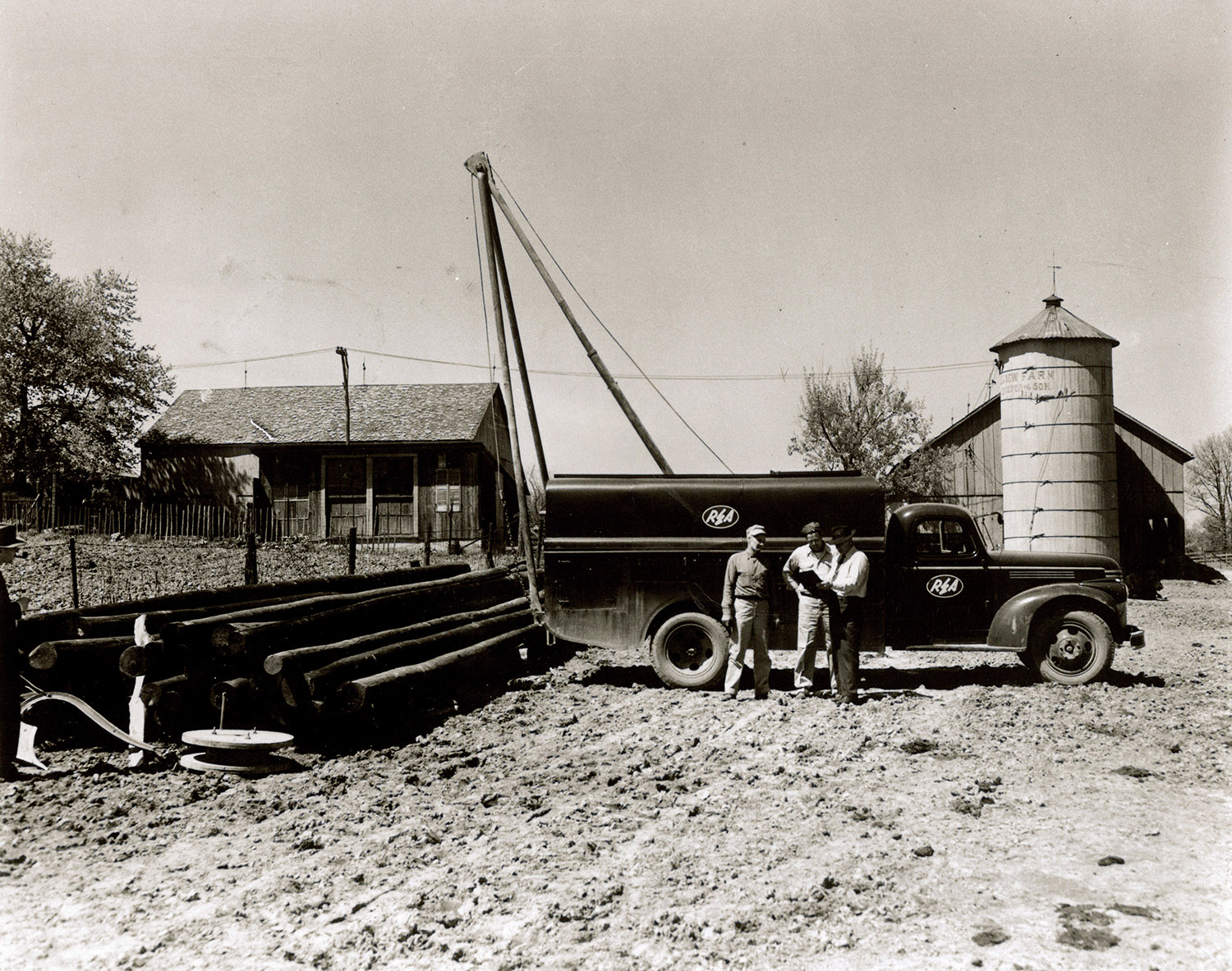 Crews installing power poles in the early days of electric cooperatives