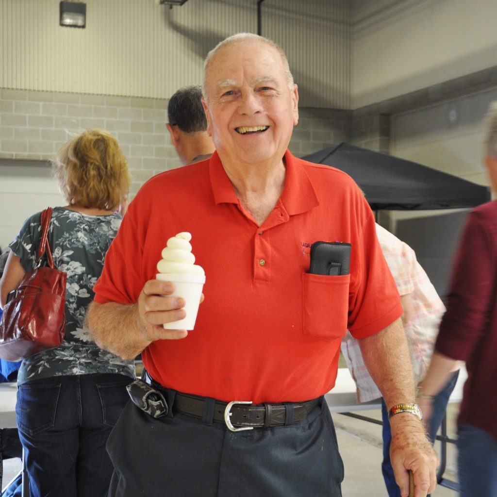 Man holding shake at annual meeting