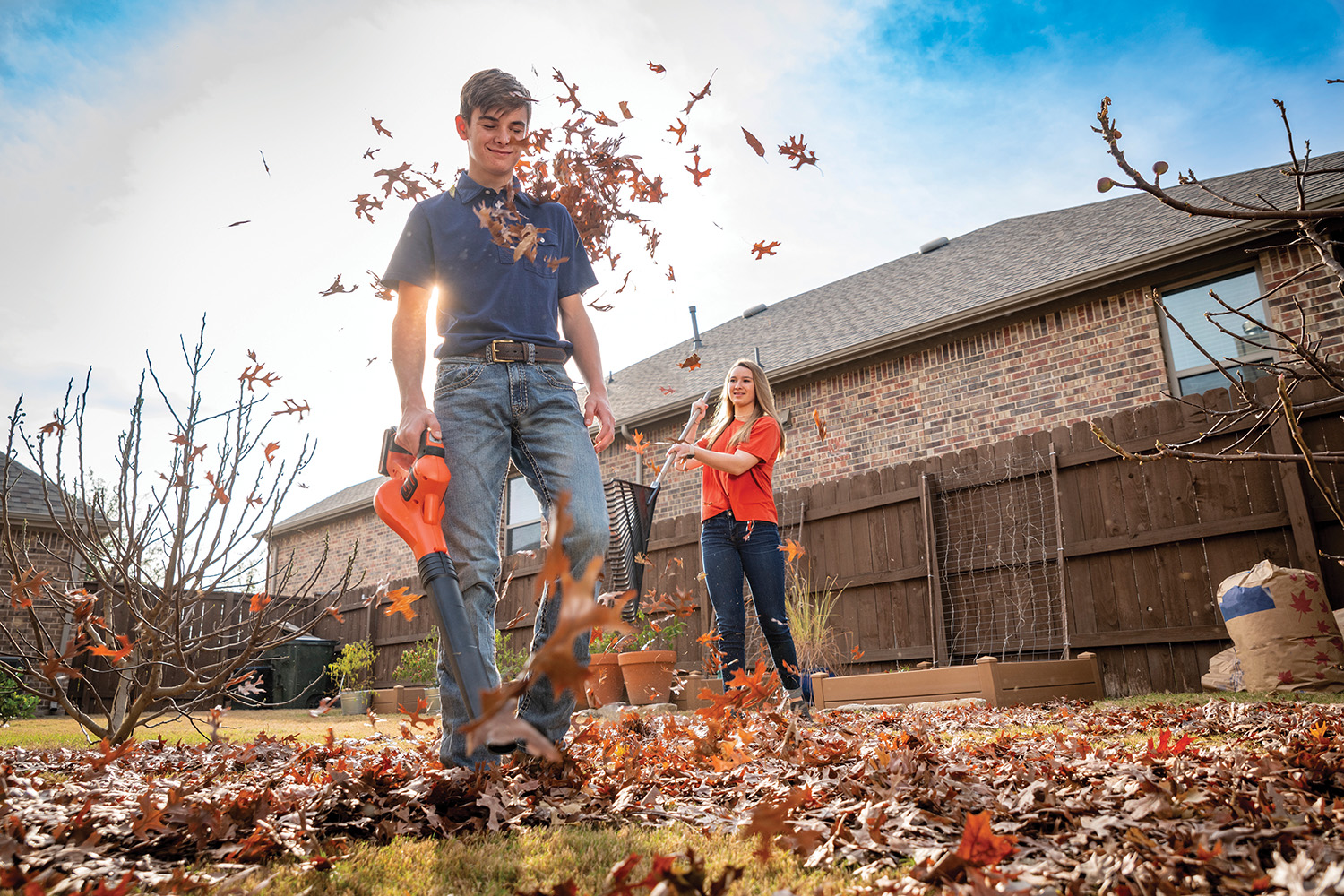 Photo of young man blowing leaves