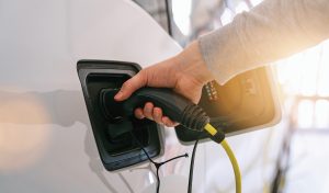 Person plugging in an electric car