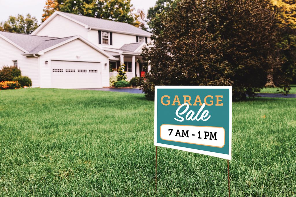Photo of house with garage sale sign