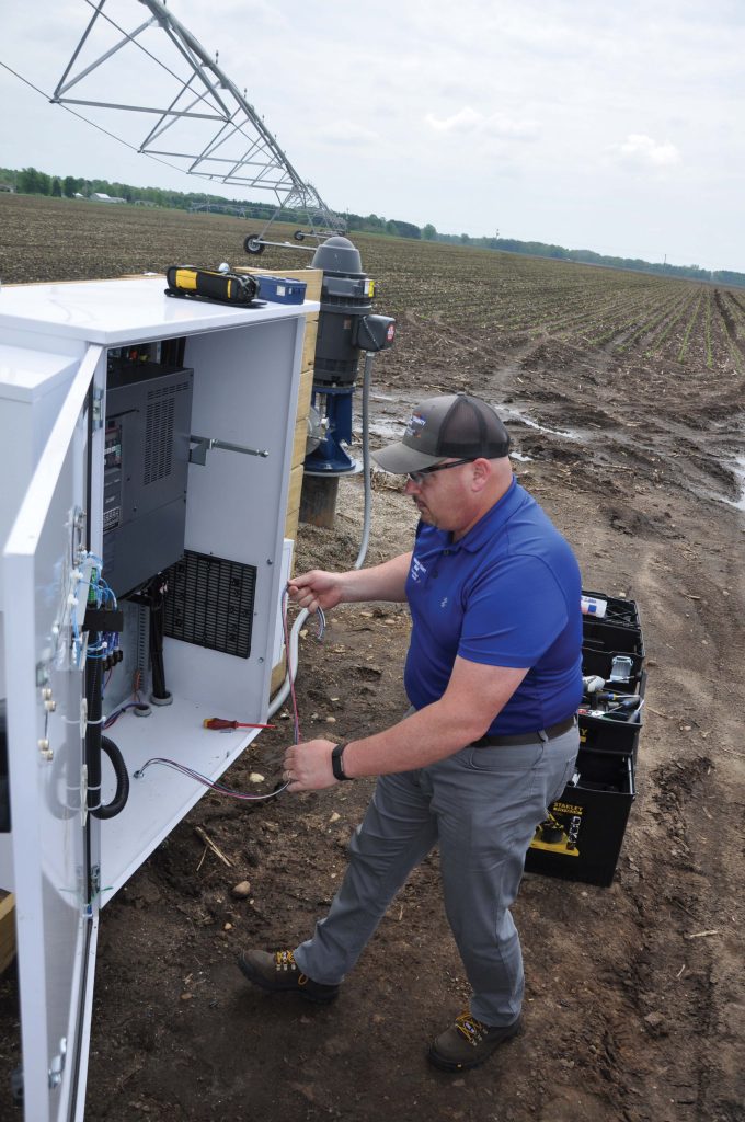 LG REMC employee Jake Taylor installing a switch on an irrigation system.