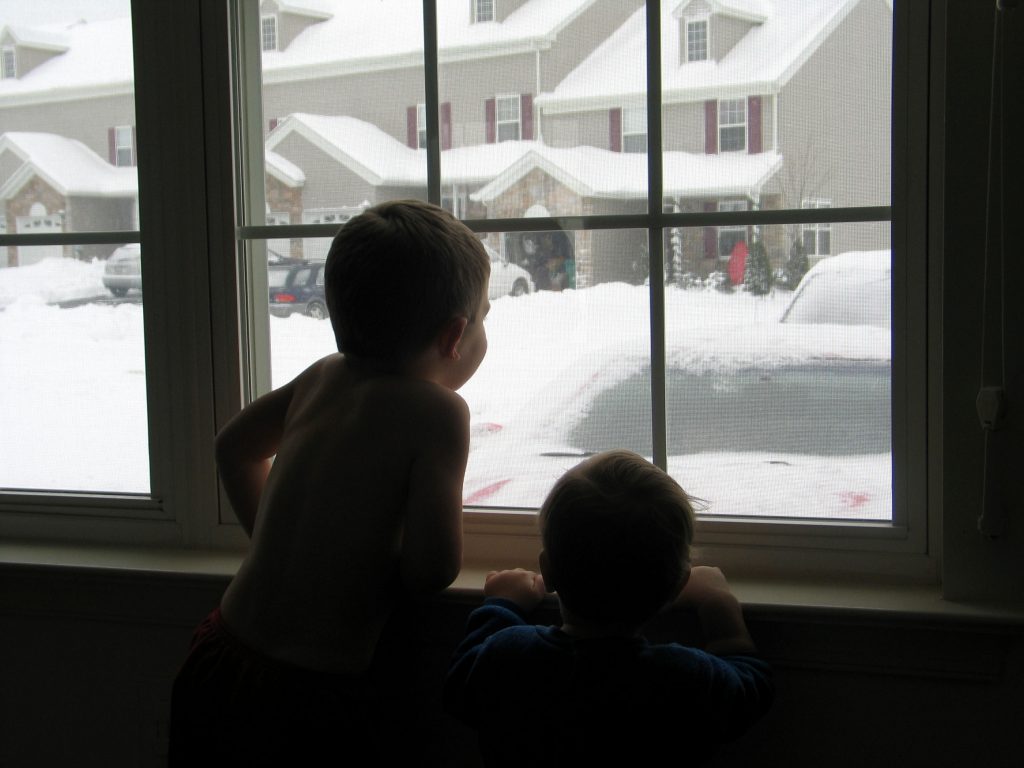 Children looking out at snow