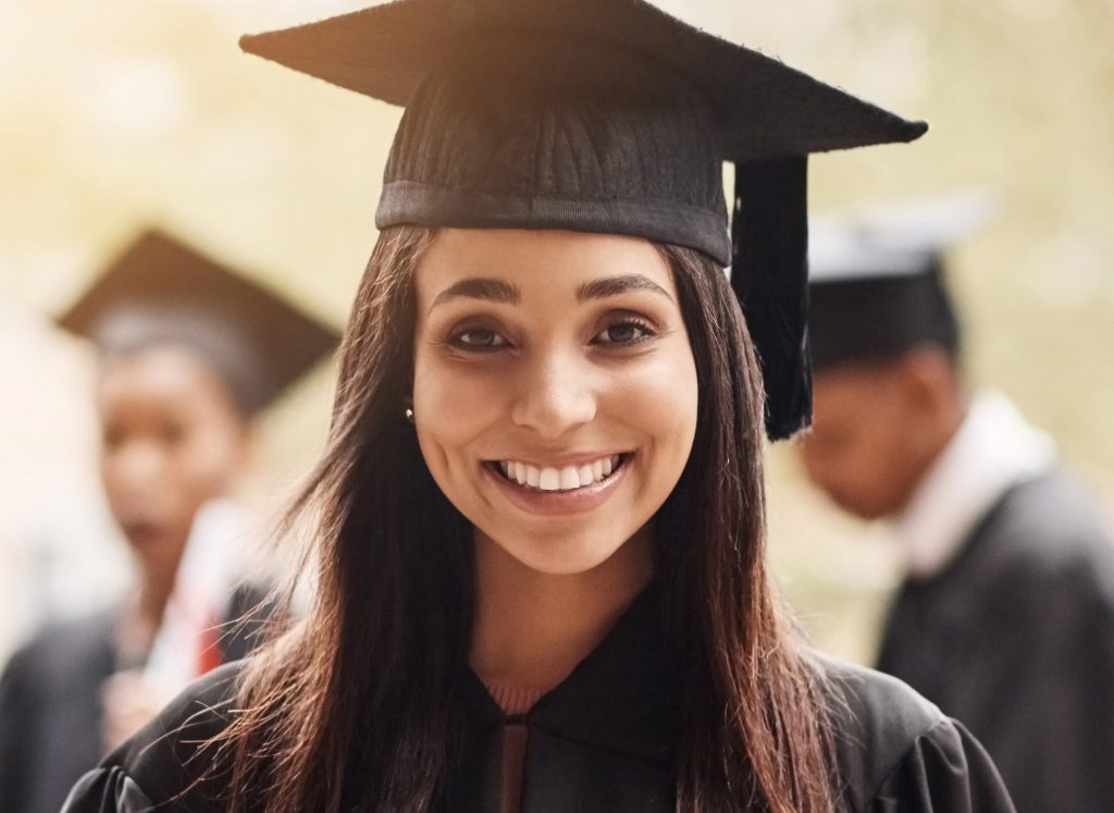 Scholarship student with cap and gown