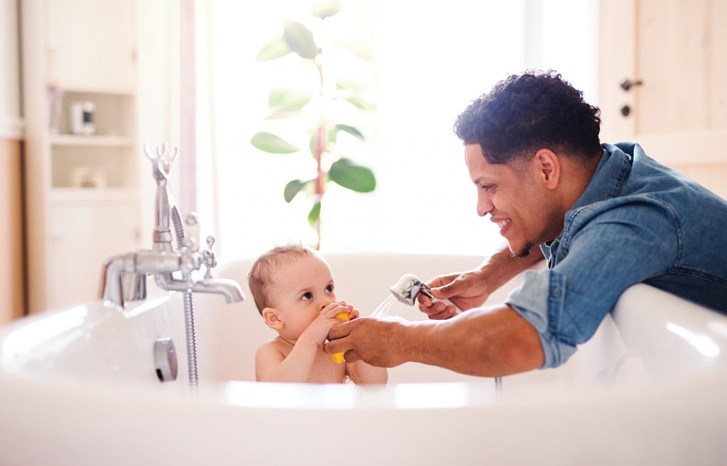 Man giving baby a bath