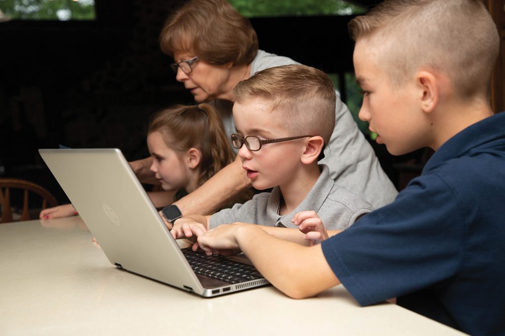 Kids looking at a laptop