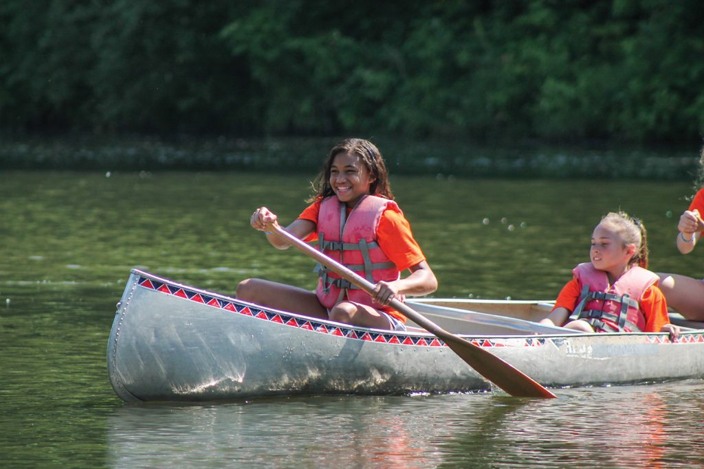 Girl canoeing at Camp Kilowatt
