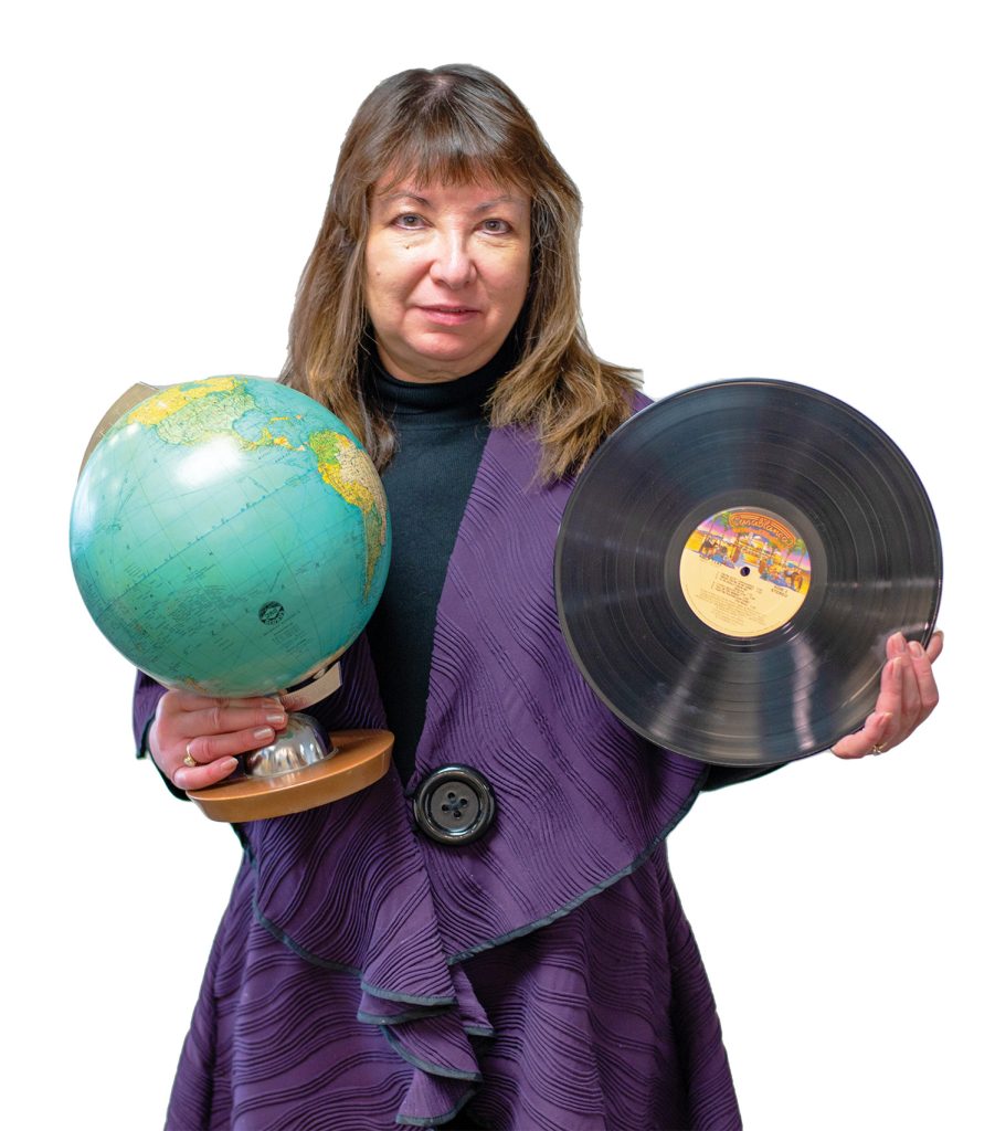 Emily holding a record and a globe