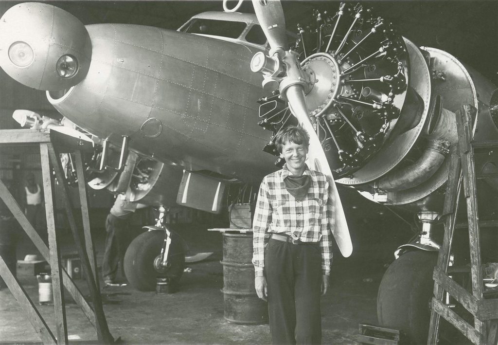 Earhart works on plane engine