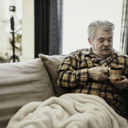 Man with blanket and coffee