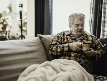 Man with blanket and coffee