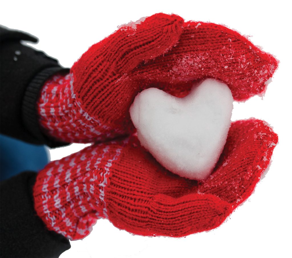 Gloved person holding heart