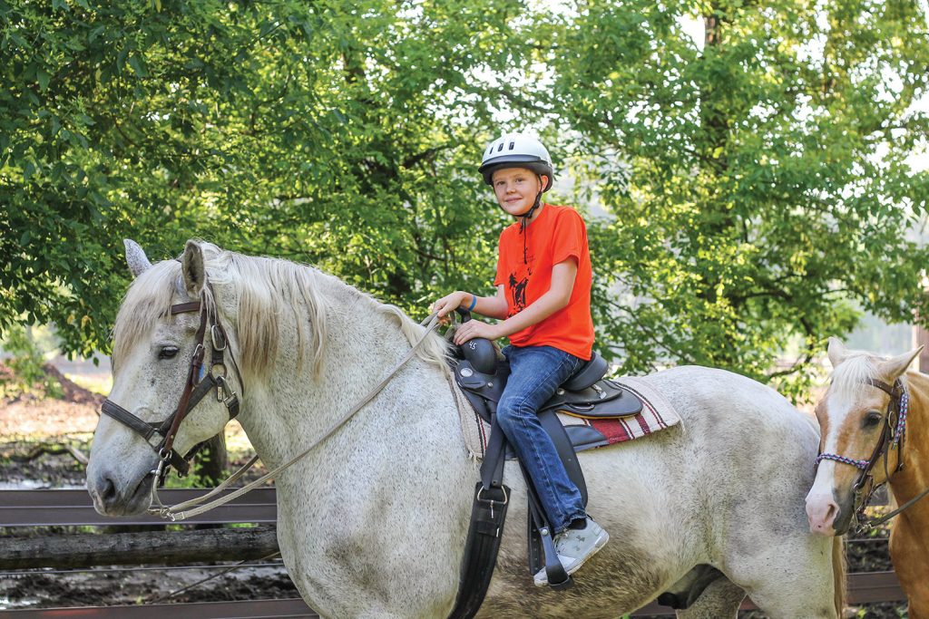 Camp Kilowatt camper on horse