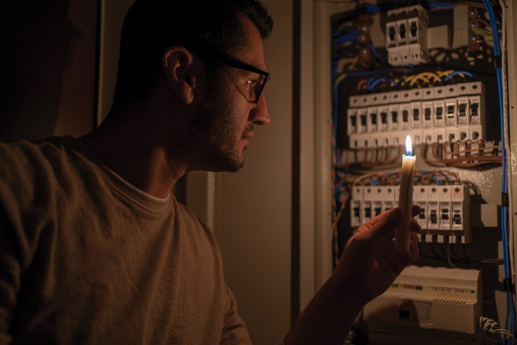 Man checking fuse box