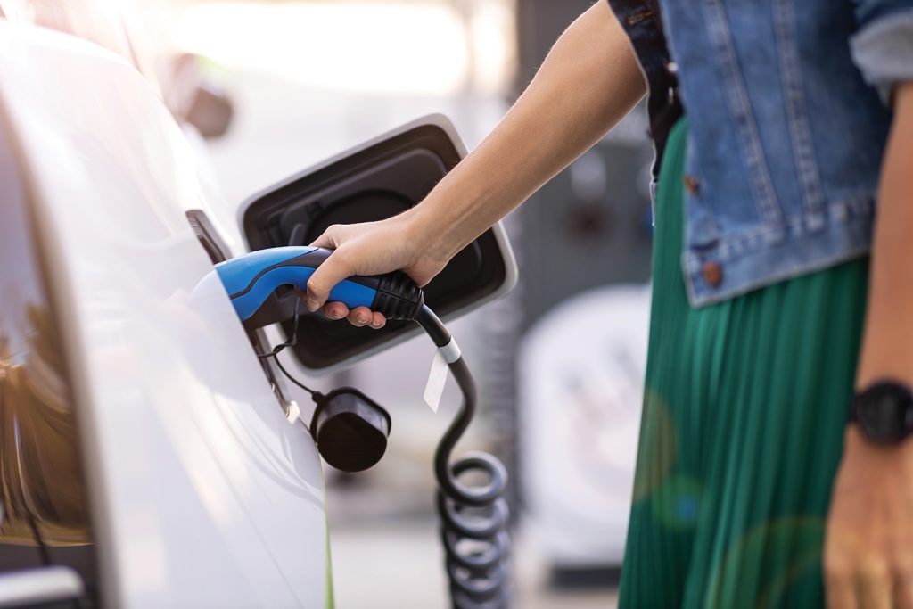 Woman charging EV