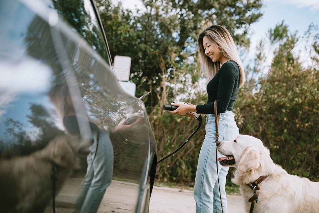 Woman charging her electric vehicle