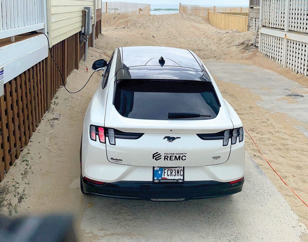 EV parked and charging at a beach