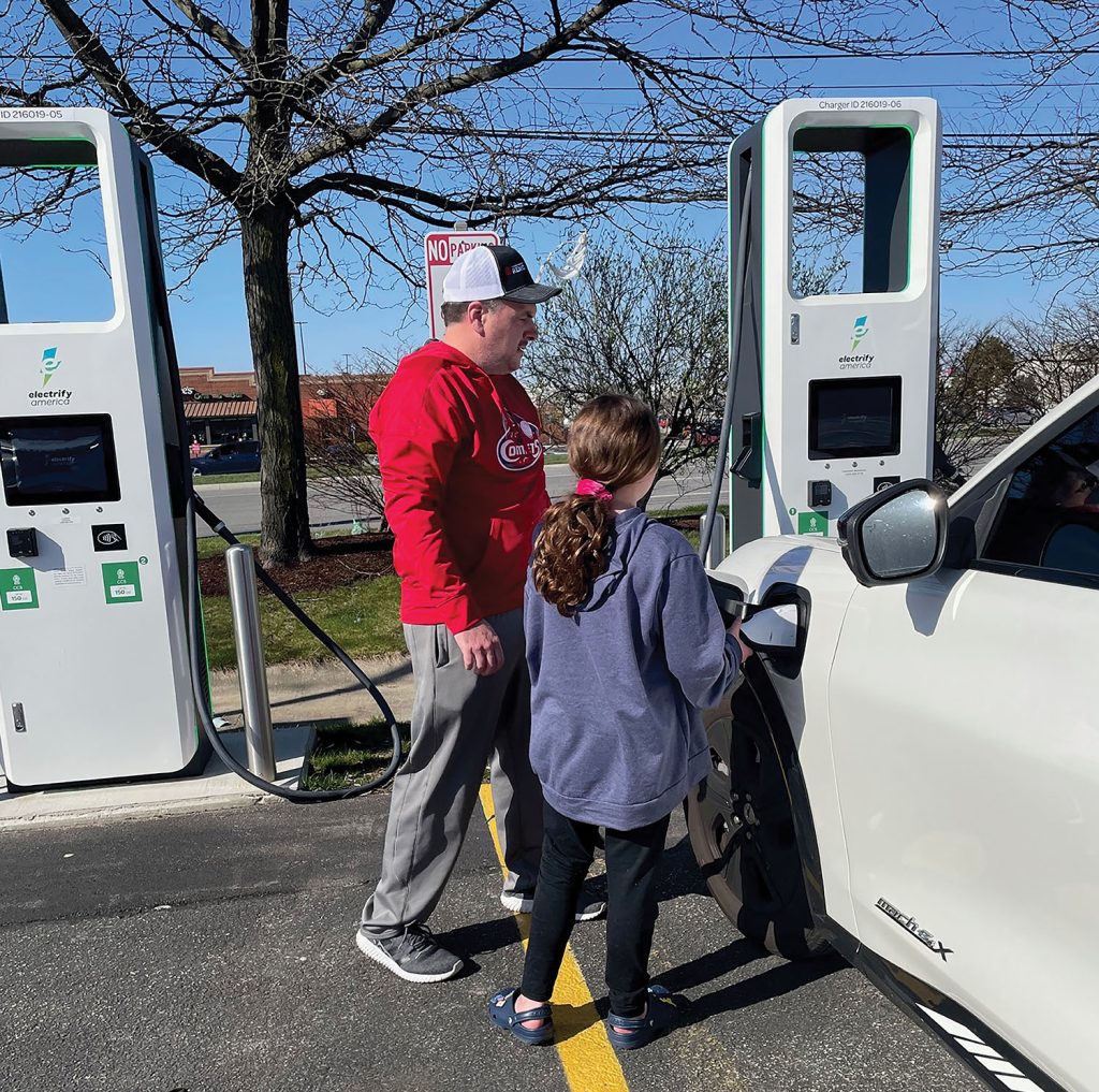 TJ and daughter at EV charger