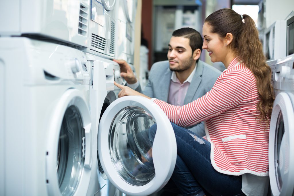 Woman and man looking at appliance